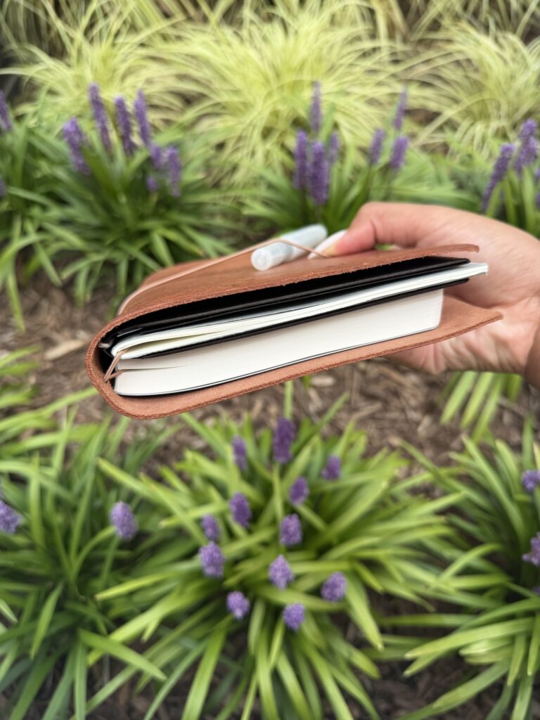 Inside my leather journal cover, showing the notebooks banded together side by side